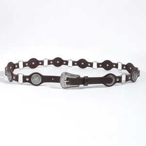 Detail of vintage western leather belt with turquoise studs and engraved silver buckle