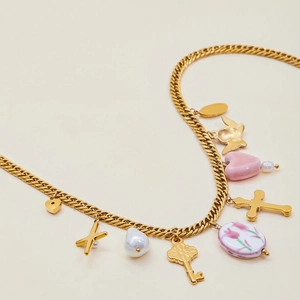 Detail of 18K gold-plated cuban chain with cross, heart, and pearl charms