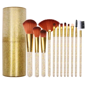 12-piece makeup brush set with clear gold glitter handles and a matching storage cylinder