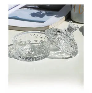 Detail of embossed relief pattern on glass jewelry jar with separate lid design
