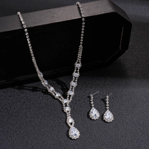 Elegant silver teardrop rhinestone necklace and earring set with V-shaped diamond pendant