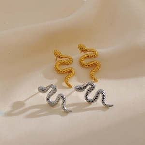 Close-up detail of snake-shaped earrings showing scale textures in gold and silver finish