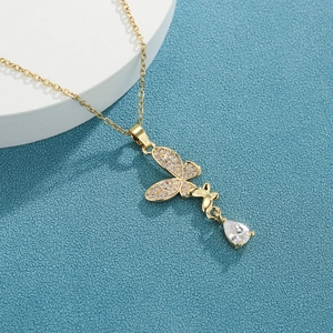 Golden micro-pave butterfly pendant necklace with zircon water drop hanging on white pedestal