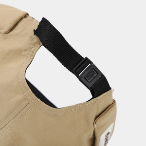 Close-up of khaki ripstop fabric with adjustable black buckle and branded woven label