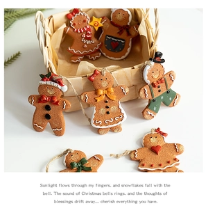 Detailed view of hand-painted resin gingerbread man ornaments with woven basket and twine
