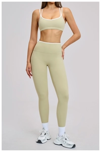 Close-up of contrast white trim on light sage green sports bra and high-waist yoga pants