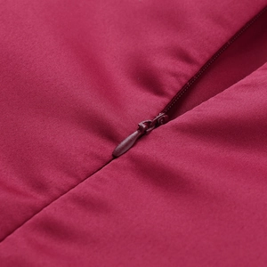 Macro detail of high-quality invisible zipper and woven fabric on burgundy lace dress