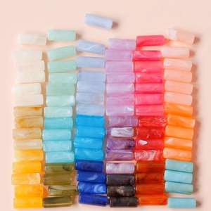 Macro shot of colorful marbled acrylic cylinder beads for DIY jewelry and necklaces