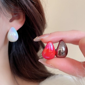 Detail of colorful acrylic teardrop earrings showing pearlescent finish and smooth textures