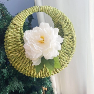 Handwoven green corn rope wall hanging basket with white peony flower for home decor