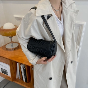French style black PU leather pleated shoulder bag for women in a natural home setting