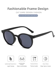 Detail view of black cat-ear fashion sunglasses with dark grey lenses on white background