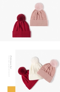Detail of chunky knit beanie texture and fluffy pom-pom in morandi color tones