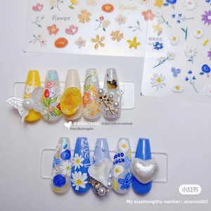 Detail showing 3D embossed floral nail stickers with resin flowers and pearls