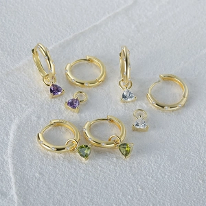 Detailed macro of S925 sterling silver triple-prong earrings with colorful zircon gems