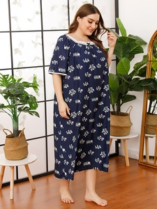 Detail of floral nightgown lace neckline with black bow on dark blue fabric