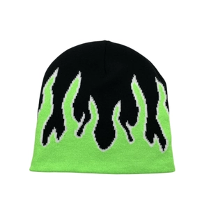Detailed close-up of the neon green flame jacquard pattern on a black knit beanie