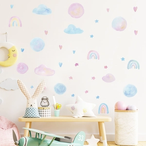 Detailed view of watercolor rainbow and cloud wall decals in a cozy children room setting