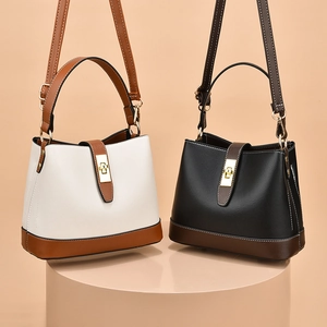 Two-tone leather bucket bags with gold twist locks and adjustable shoulder straps