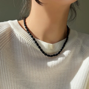 Elegant 925 sterling silver necklace with black agate beads on a white knit sweater