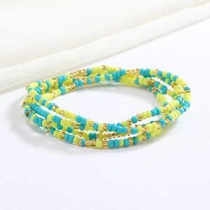 Macro detail of multi-layer beaded waist chain in blue, neon green, and gold beads