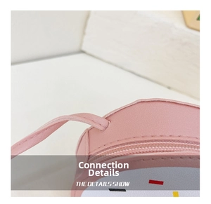 Close-up of durable shoulder strap stitching and zipper detail on pink donut bag