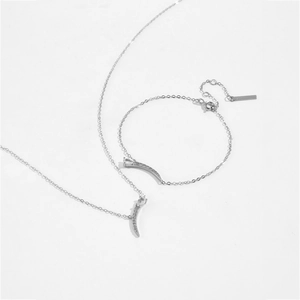 Detailed view of silver s925 crescent moon necklace and bracelet set with white zircon