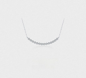 Close-up of a silver S925 sterling silver curved bar necklace with sparkling zircons