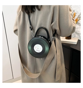 Detail view of the black vinyl record bag featuring musical texture and silver hardware