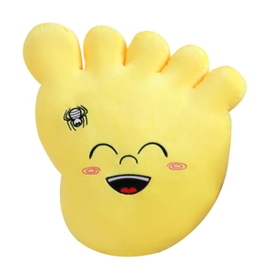 Creative yellow big foot plush pillow with smiling face embroidery on white background