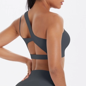 Close-up of dark grey yoga set with cutout back sports bra and high-waisted leggings