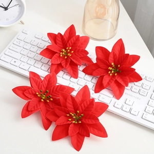 Vibrant red poinsettia Christmas flowers with green stamens for festive tree decoration
