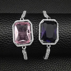 Macro detail of rectangle cut gemstone bracelets in pink and purple with diamond accents