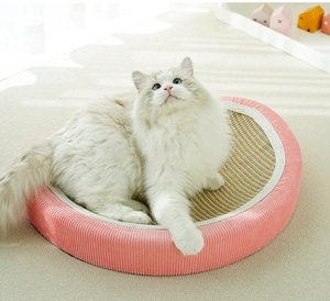 Pink round sisal cat scratcher bed with corduroy edge and a fluffy cat resting