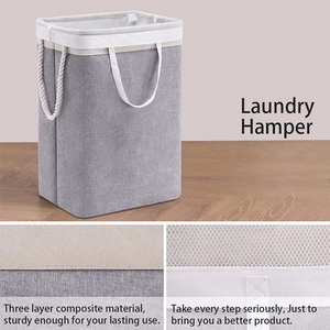 Detail of grey laundry hamper with sturdy rope handles and protective mesh drawstring top