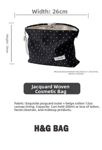 Black polka dot jacquard cosmetic bag with 26x18cm dimensions and pearl zipper puller