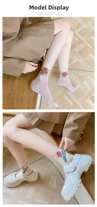 Detail of cotton mid-calf socks featuring 3D floral embroidery and ribbed cuffs