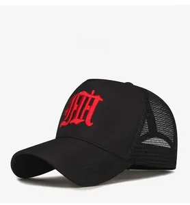 Detail view of black trucker hat with breathable mesh and red Gothic embroidery