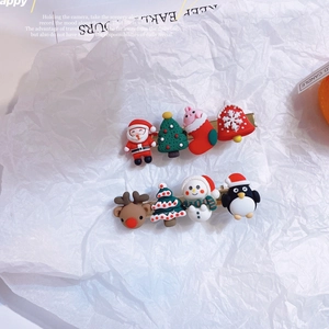 Detail of Christmas cartoon hair clips featuring Santa, reindeer, and snowman designs