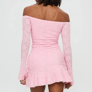 Close-up of pink lace texture and off-shoulder long sleeve detail on a slim mini dress