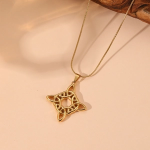 Detail of gold stainless steel Celtic knot pendant with opal and sparkling crystal inlay