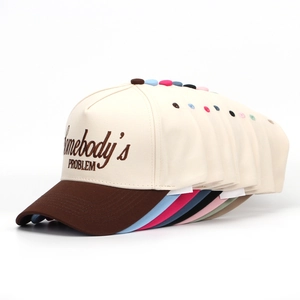 Detail showing various colors of Somebody's PROBLEM embroidered baseball caps