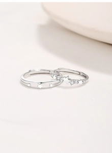 Detailed close-up of S925 sterling silver couple rings with star patterns and zircon stones