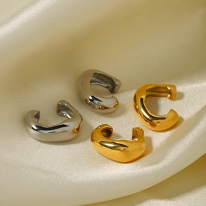 Minimalist 18k gold and silver stainless steel C-shape stud earrings on silk fabric