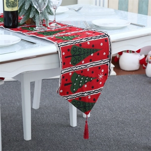 Knitted Christmas table runner with red festive patterns, green trees and red tassels