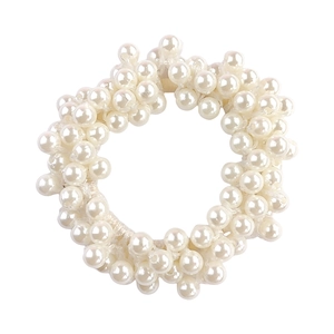 Close-up of white elastic hair tie made with multiple sized faux pearls on white background