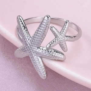 Macro shot of silver starfish ring featuring detailed texture and adjustable open band