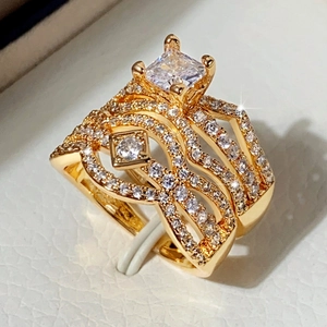 Luxury gold ring set with square zircon center stone and sparkling wave diamond band