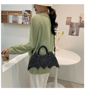 Side view of a creative black bat handbag featuring contrast spider web stitching on a woman
