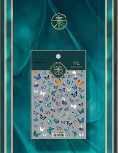 Detailed view of TS-122 colorful 5D butterfly nail decals on premium green silk background